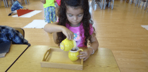 students using Montessori decimal beads to understand place value