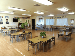 a child developing responsibility while cleaning up the Montessori classroom
