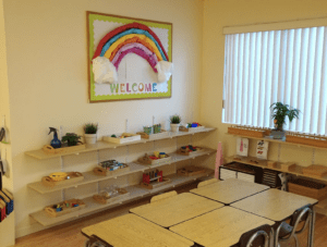 a child exploring size gradation with Montessori pink tower materials