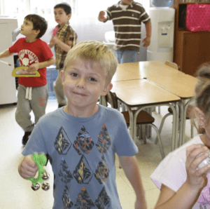 a child studying animal life cycles using Montessori zoology materials