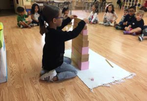 students exploring the solar system using Montessori cosmic education materials