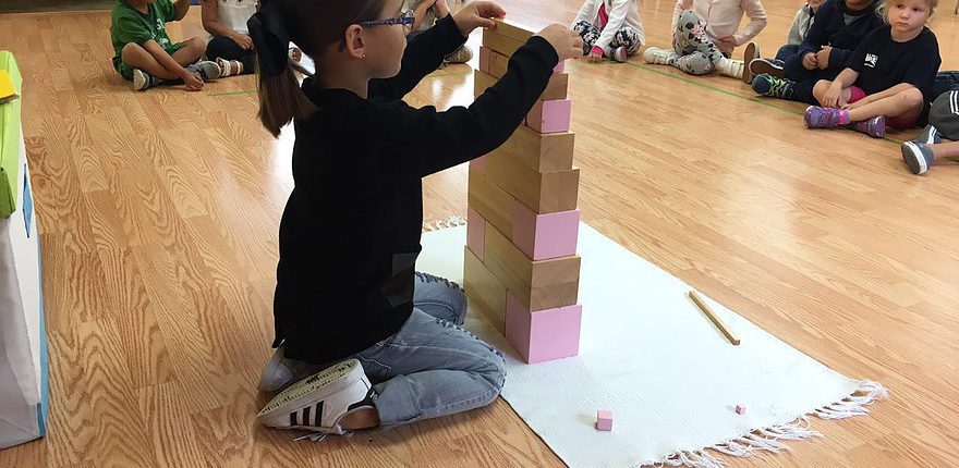 students exploring the solar system using Montessori cosmic education materials