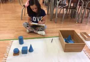 a child counting Montessori beads, building early math skills