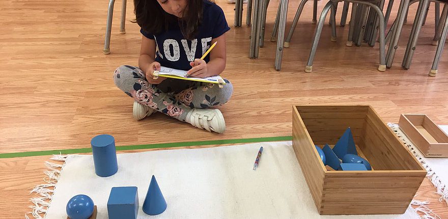 a child counting Montessori beads, building early math skills