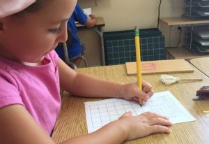 a child counting Montessori beads, building early math skills