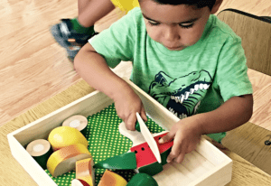 a child constructing geometric figures with Montessori constructive triangles
