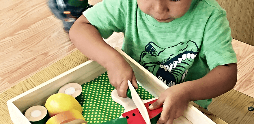 a child constructing geometric figures with Montessori constructive triangles