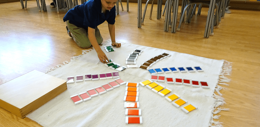 a child practicing phonics with Montessori movable alphabet and objects