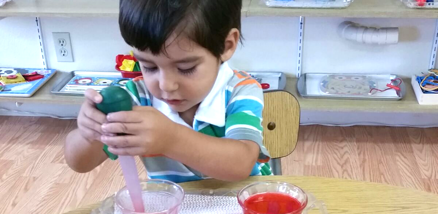students practicing early writing skills with Montessori movable alphabet