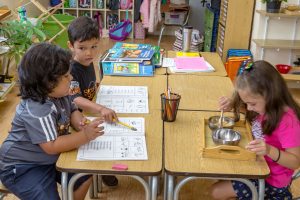 a child tracing metal insets to prepare for handwriting and pencil control