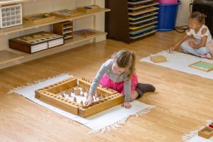 children practicing water pouring exercises to improve coordination and concentration